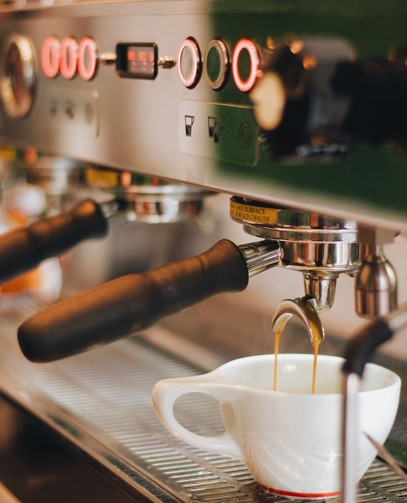 vegan coffee being poured from an espresso machine 