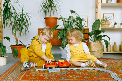 two children playing with train together  - play development