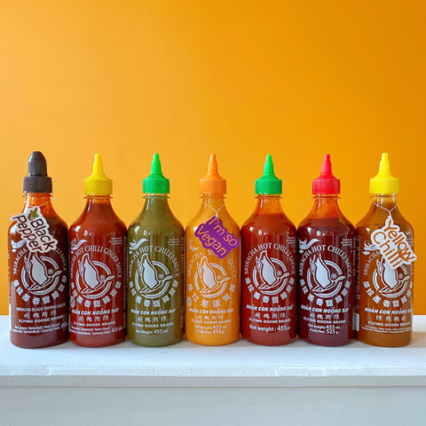 Seven bottles of Thai Sriracha Hot Chilli Sauce in Different Flavours