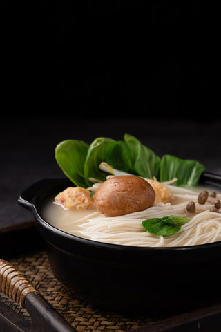 Bowl of Soup Ramen Noodles with Shiitake Mushrooms, Enoki Mushrooms and Bak Choi or Pak Choi