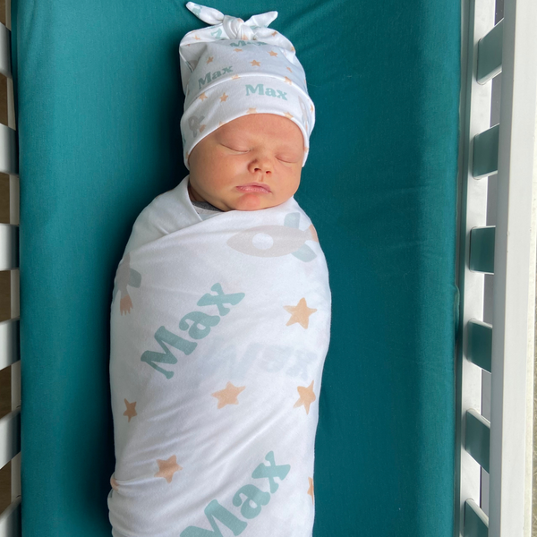 personalized swaddle and hat set with rockets and stars