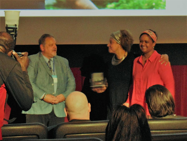 2019 Visionary Award winner Frances-Ann Solomon being presented Her Pierre Laurent Cinema watch by Jay Cameron, Director Sales and Marketing Pierre Laurent and Tonya Williams 