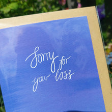 Load image into Gallery viewer, Close up view of the card showing the different blues within it as well as a closer look at the white calligraphy which says &#39;Sorry for your loss&#39;
