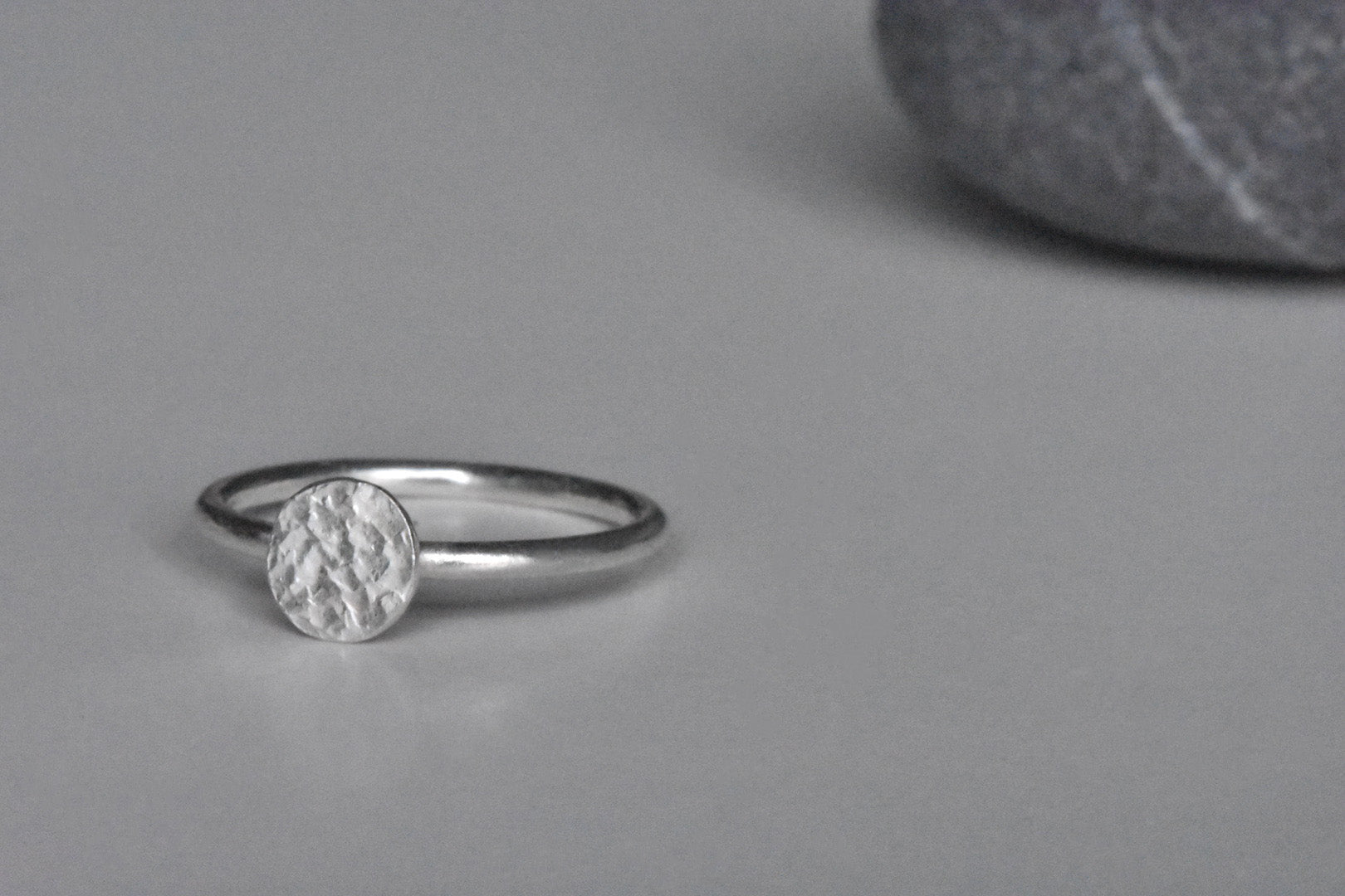 Handmade Eco Silver Textured Coin Stacking Ring, coin facing slightly to the left.