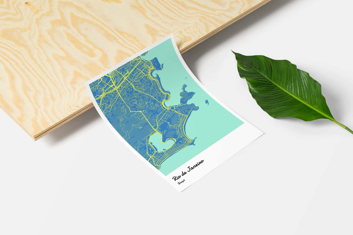 Unframed map art print next to a leaf to symbolize our green paper.