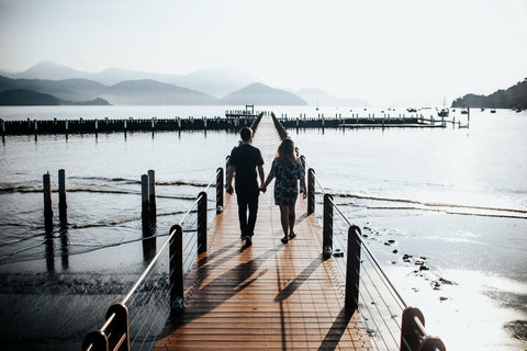 Man and Woman walking on a pier
