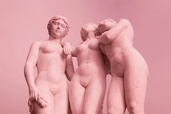 three pink nude female statues