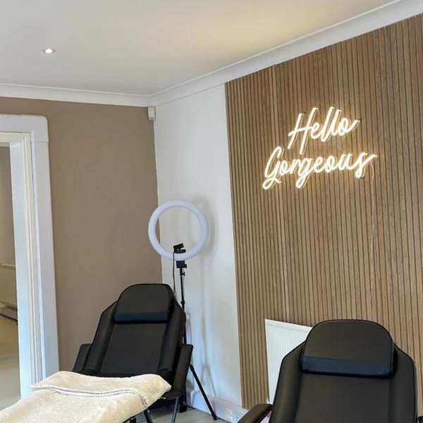 Hello Gorgeous Neon Art in the colour warm white installed in the wall of a beauty businesses's wall.