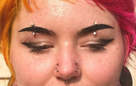 centered eyebrow piercing 