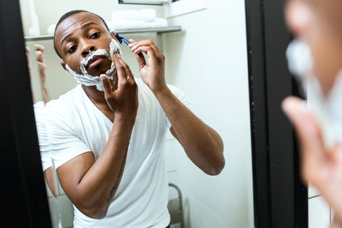 Black man giving himself a great shave.