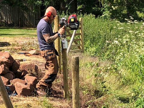 Ben Rodenhurst using his petrol post driver with UKA adapter to knock in a 4" timber stock fence