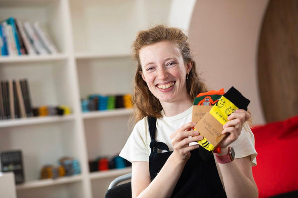 Lucy Jeffrey Bare Kind founder holding Bare Kind socks