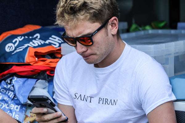 Saint Piran cyclist in a Saint Piran branded white t-shirt