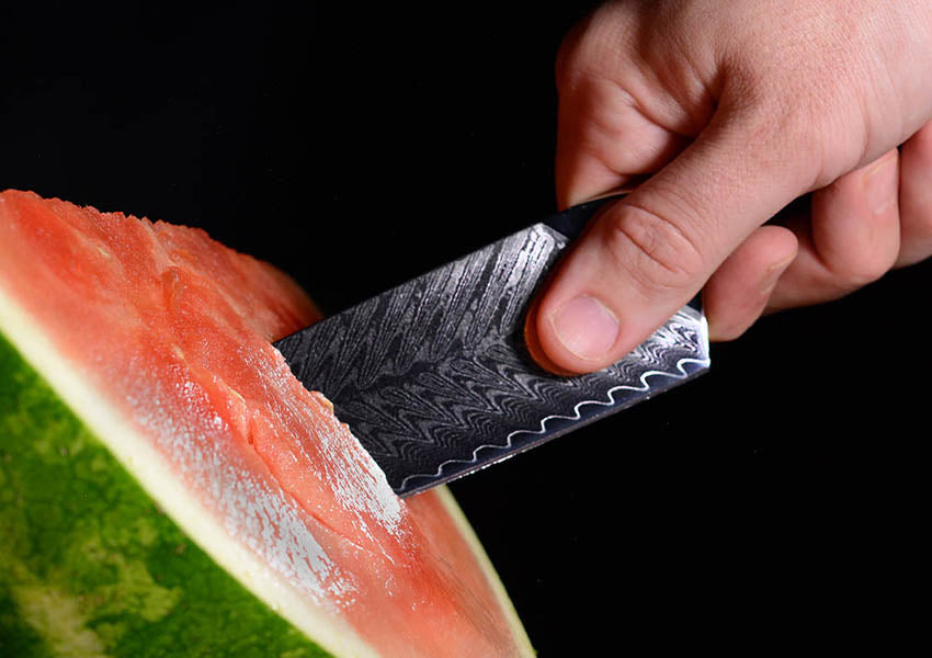 Man cutting watermelon using the pinch grip