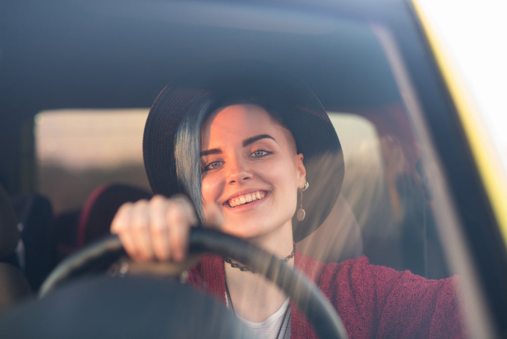 A Young Woman driving in closed car cabin