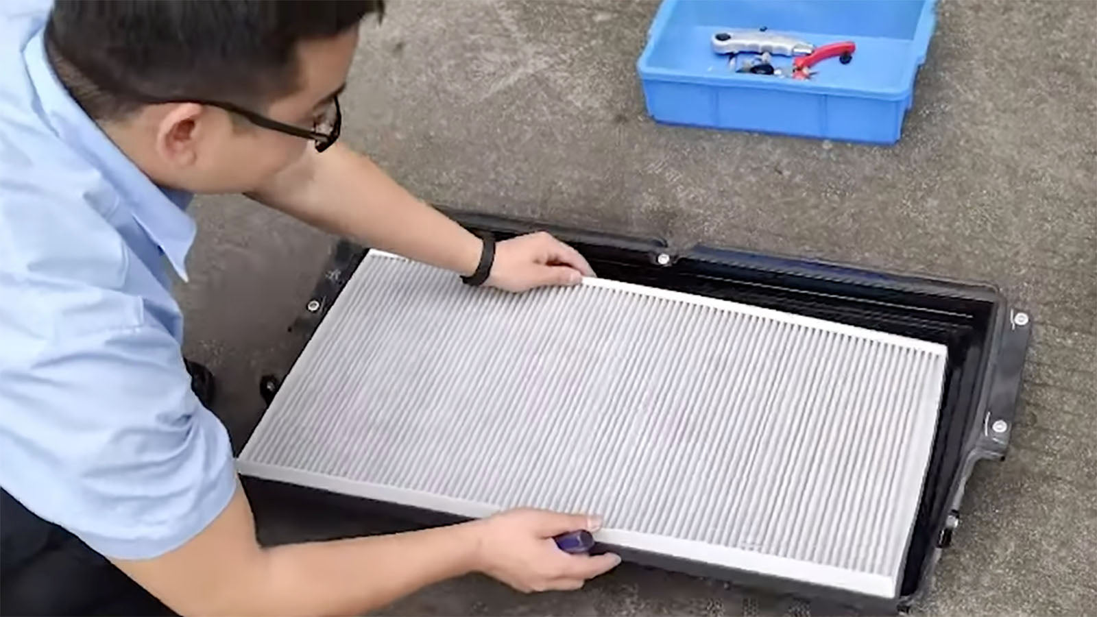 A Guy Installing his Tesla Cabin Air Filter