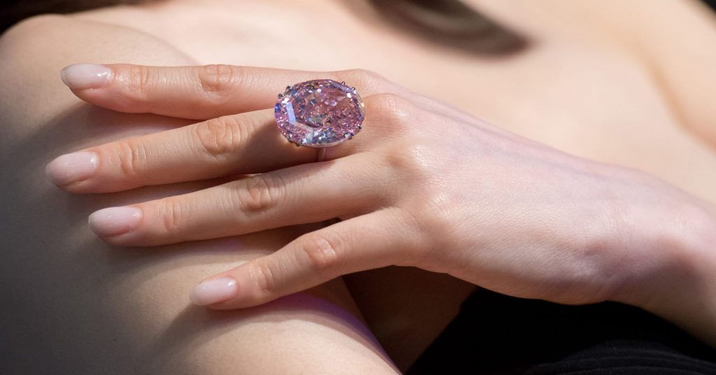 female hand with pink star diamond