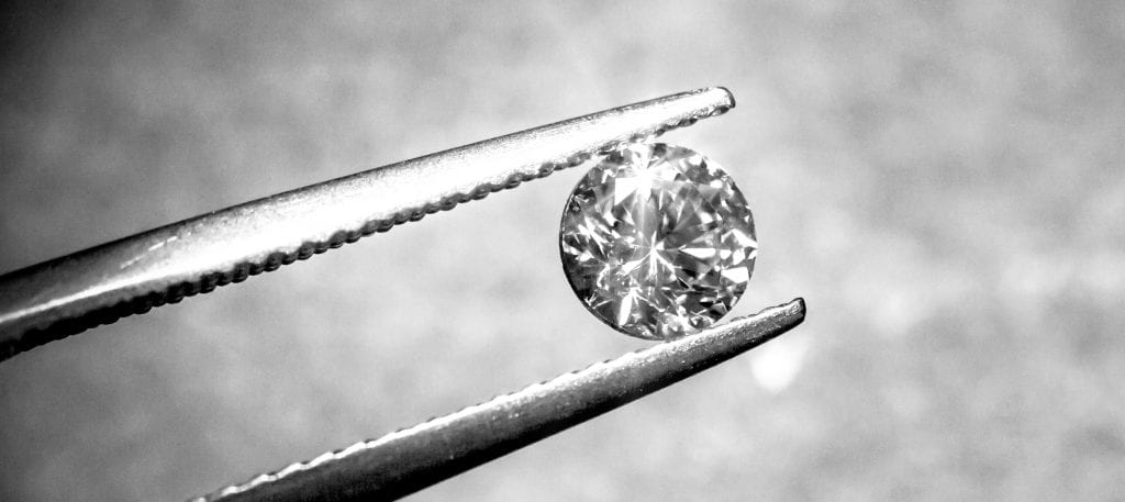 brilliant diamond in tweezers to see craftsmanship