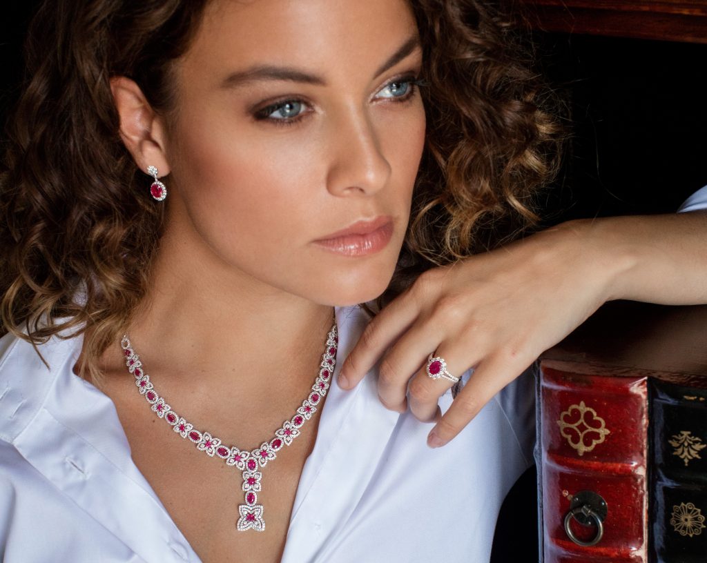 woman wearing ruby necklace, earrings and ring