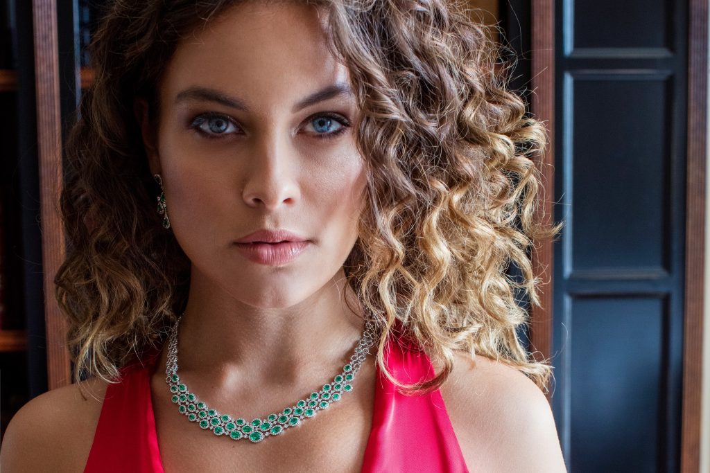 woman wearing emerald necklace