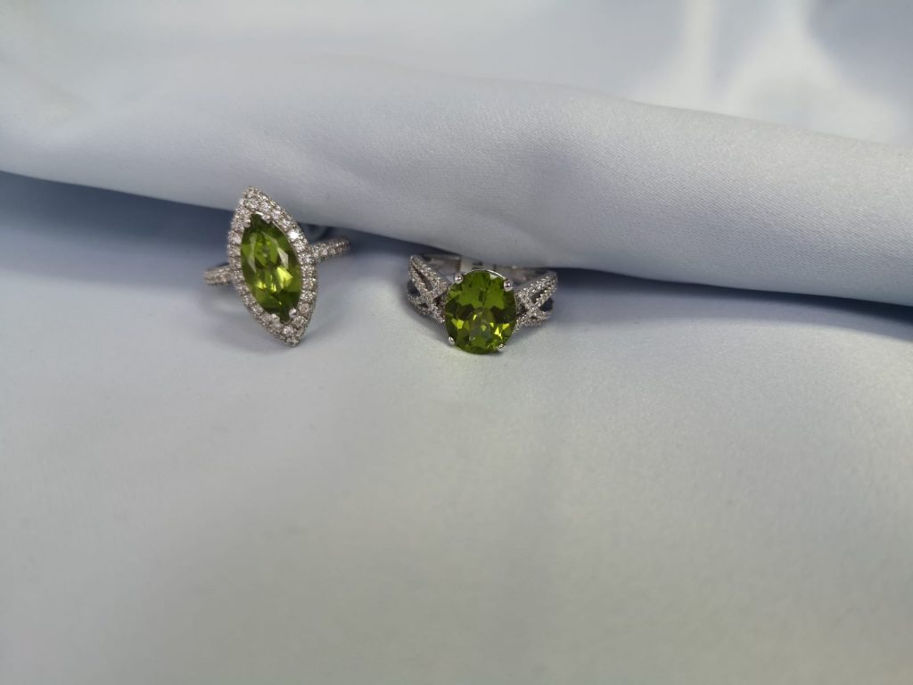 two rings with peridots and diamonds