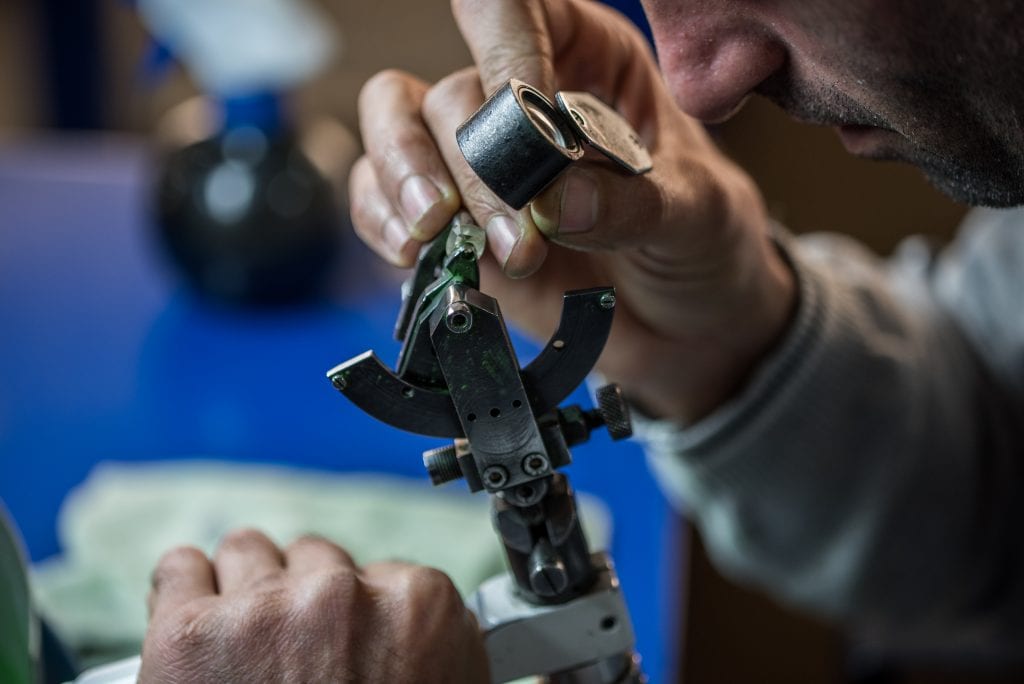 diamond polisher looking at rough diamond