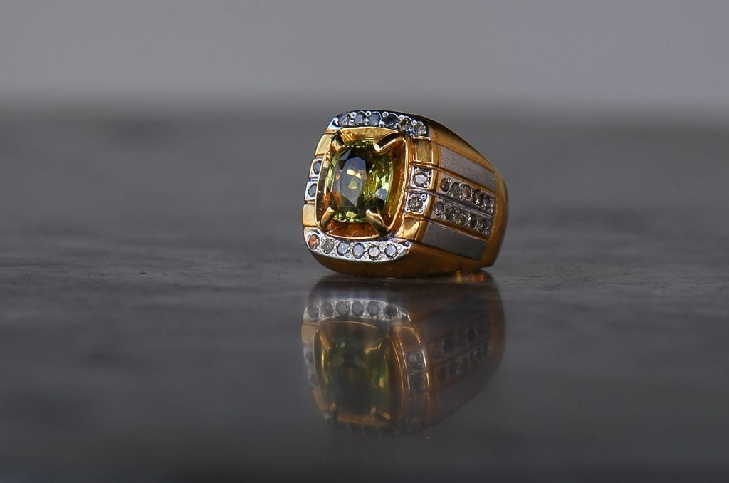 gold ring with rare green chameleon diamond in it