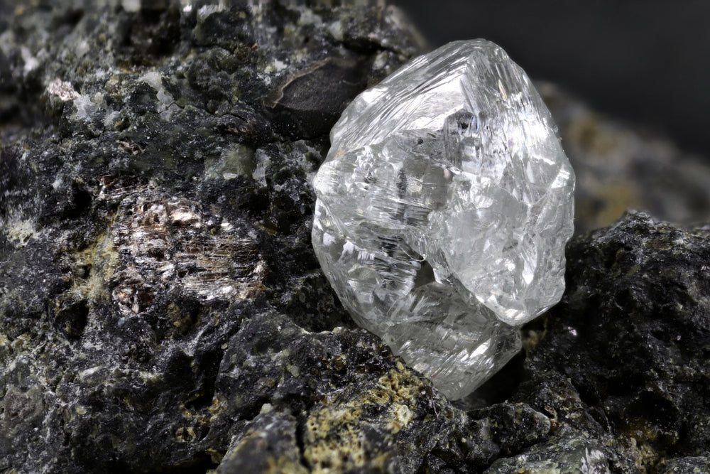 a rough diamond inside kimberlite