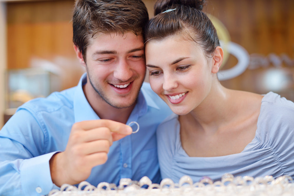 man and woman looking at rings