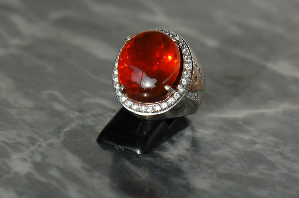 fire opal ring on dark background