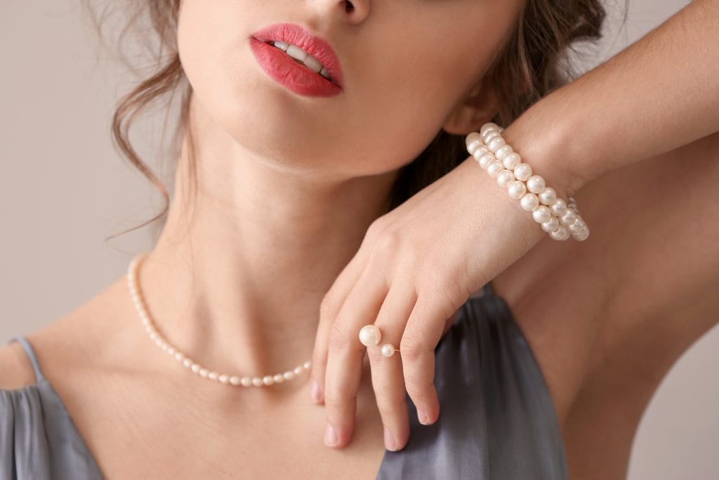 woman wearing birthstone june pearl jewelry