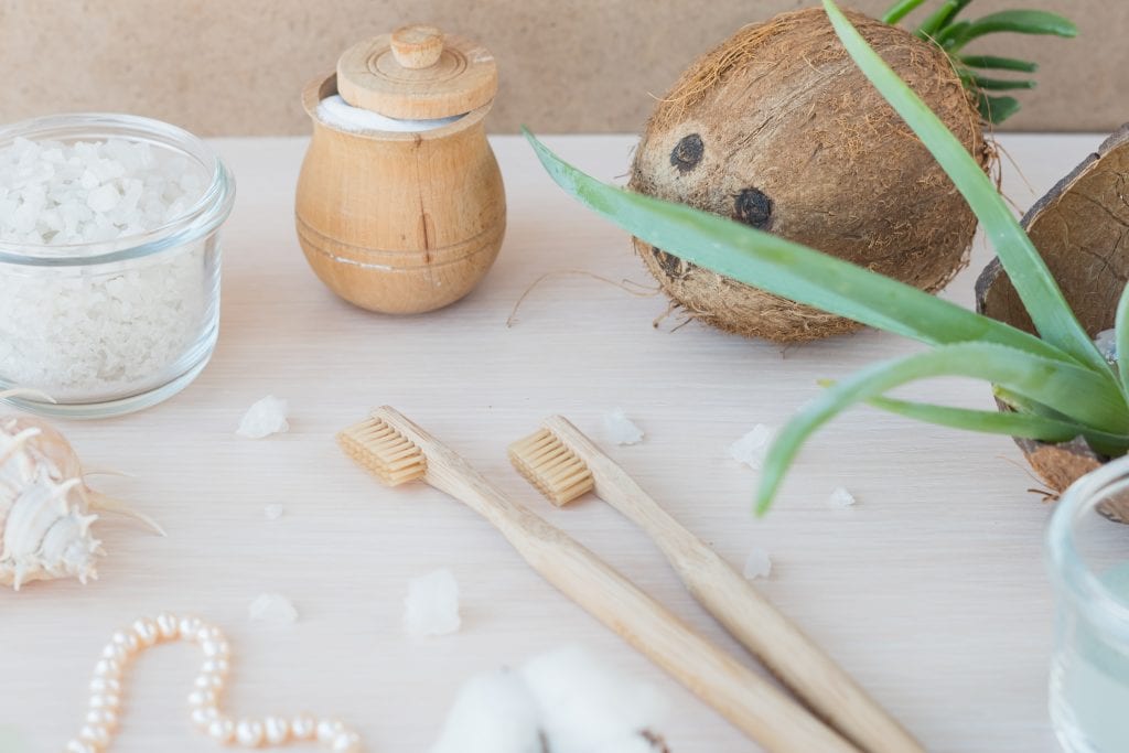 pearls in natural setting with toothbrush and coconut