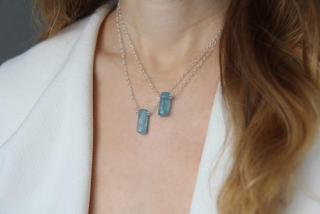 woman wearing birthstone march aquamarine jewelry