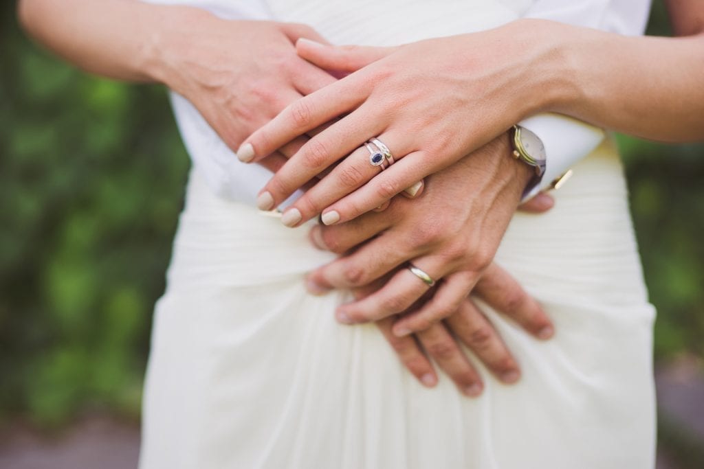 woman wearing diamond engagement ring with sapphire