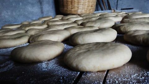 Bread loaves proving on bench.