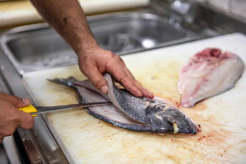 Chef preparing Australasian snapper or silver seabream