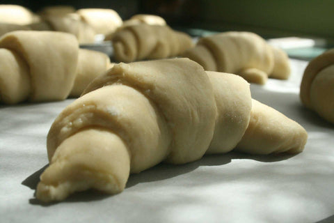 Dough shaped in croissants, ready for baking.