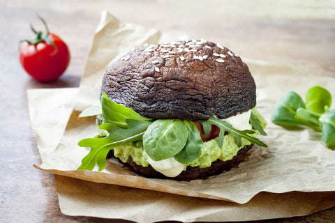 Raw Dehydrated Portobello Mushroom Vegetarian Burgers with Avocado, Tomato, Salad and Red Capsicum