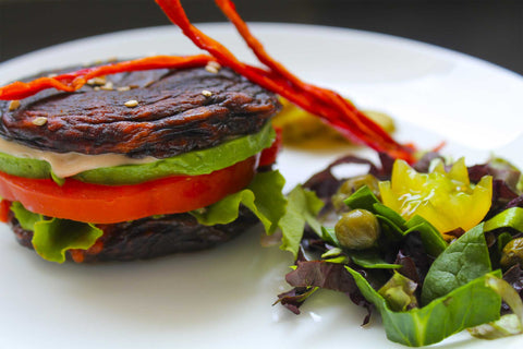 Raw Dehydrated Portobello Mushroom Vegetarian Burgers with Avocado, Tomato, Salad and Red Capsicum