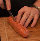 Slicing a sausage lengthwise.
