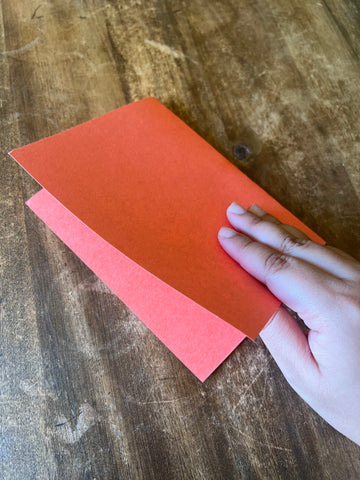 Fold the construction paper in half