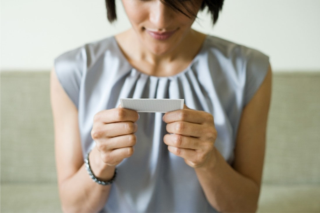 Woman Holding a Business Card