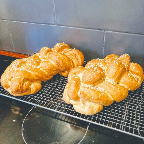 Baked Challah bread on cooling racj