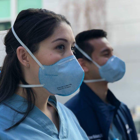 two medical professionals properly wearing an n95 mask