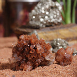 Aragonite crystal clusters displayed in front of golden pyrite