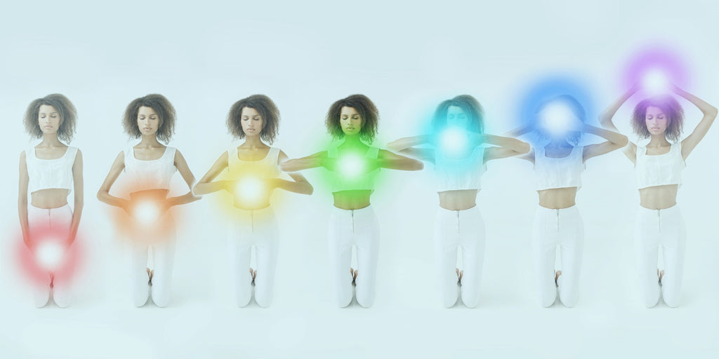 A row of women with each of the seven chakras lit up against the respective area of the spine