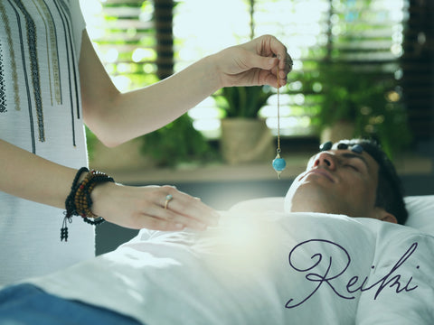 A reiki practitioner uses crystal healing to align chakra points during a reiki session