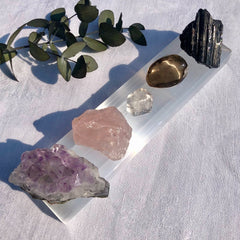 Selenite charging bar covered with essential healing crystals