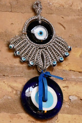 Ancient evil eye protective amulet relic hanging on a wall