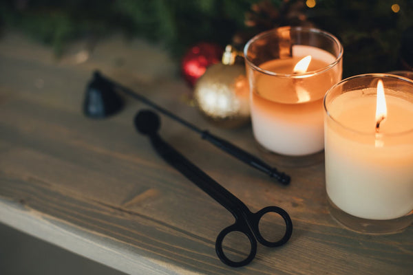 Christmas candles scene with a candle snuffer and Christmas decorations